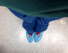 Photo pointed downward of scrubs and shoe protectors