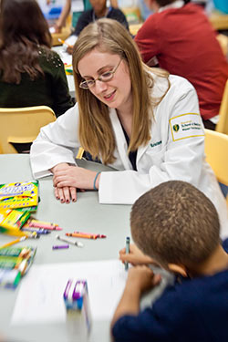 photo of a medical student with a child