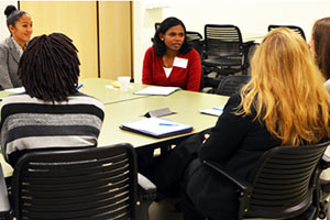 four attendees seated in a small group at the conference