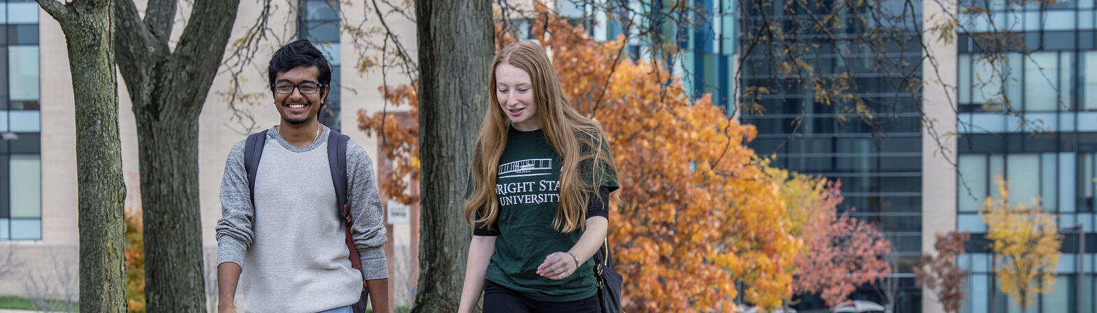 photo of two students walking outside on campus