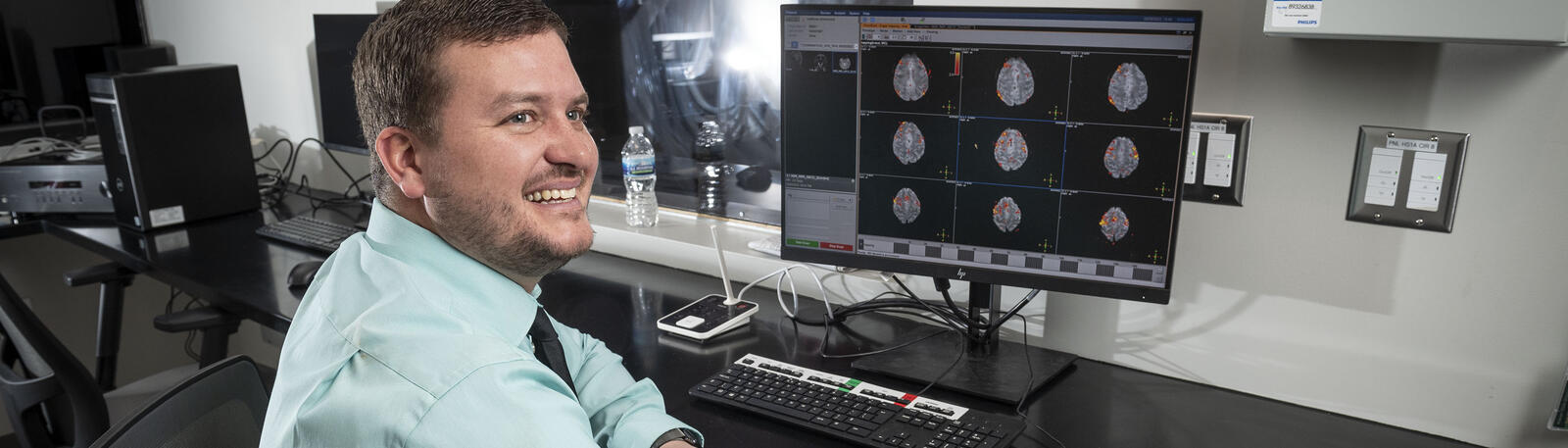 photo of a faculty member sitting in front of a computer