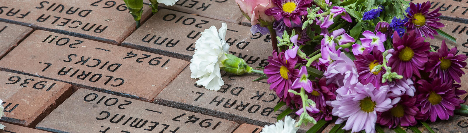 photo of flowers on engraved brick pavers at rockafield cemetery