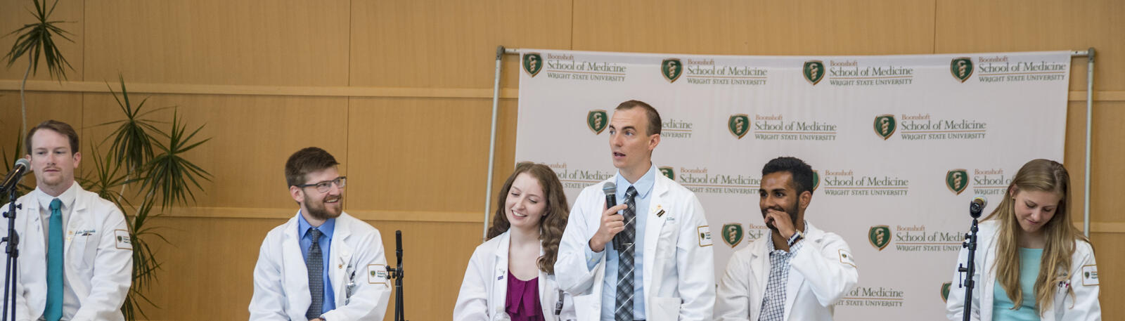 photo of medical students speaking to a crowd of people