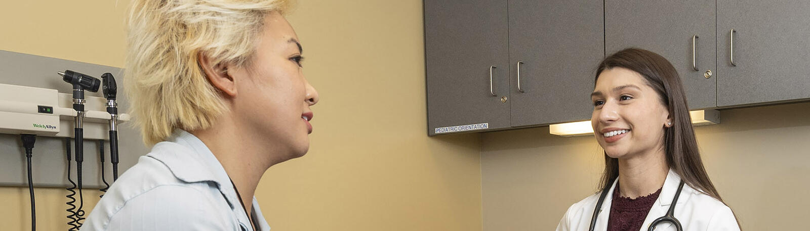 photo of a resident and patient in an exam room