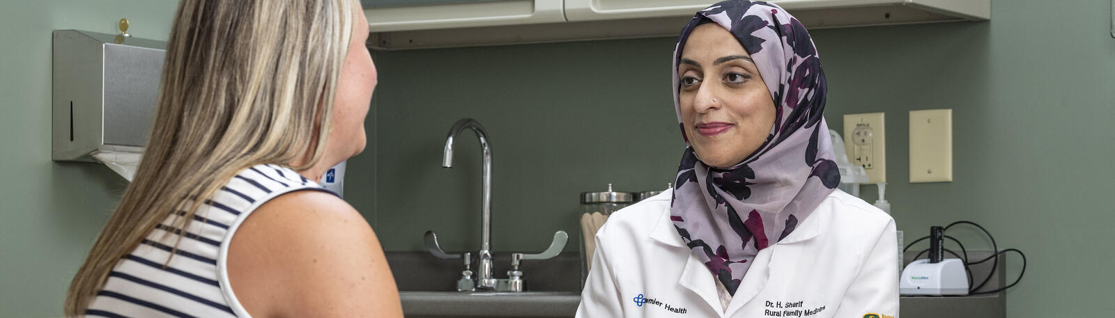 photo of a resident and patient in an exam room