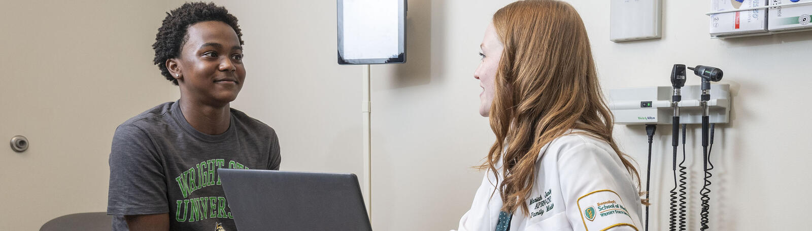 photo of a resident and patient in an exam room