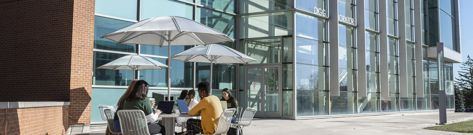 photo of students at a table in front of diggs lab