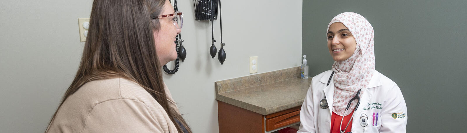 photo of a resident and patient in an exam room