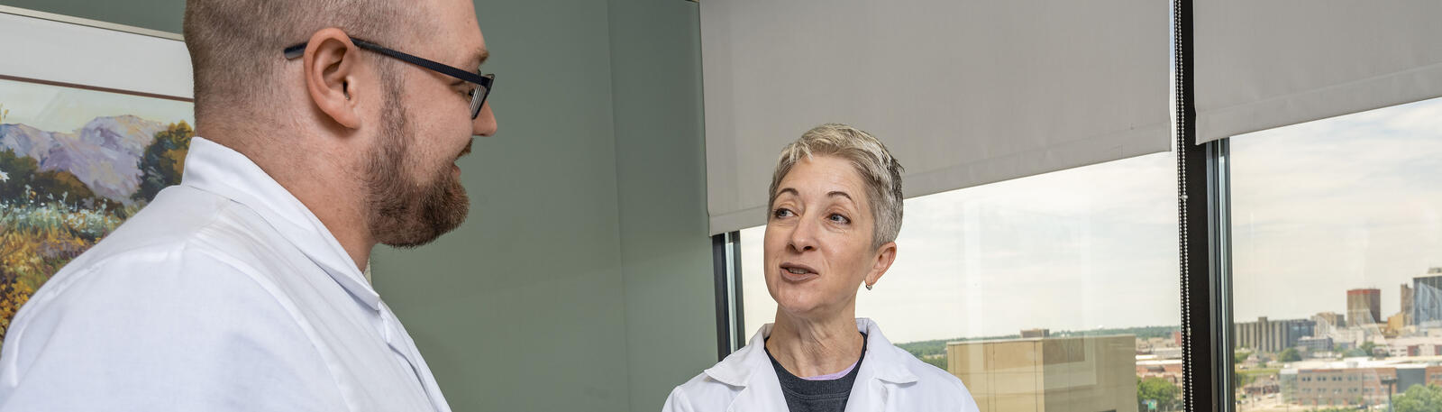 photo of a resident and physician in a hospital room