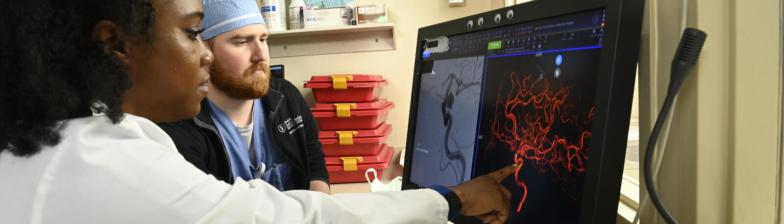 A student looking at a screen with a fellow