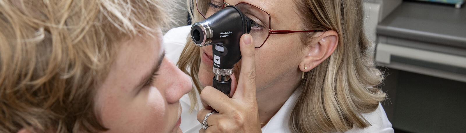 photo of a resident in an exam room with a patient