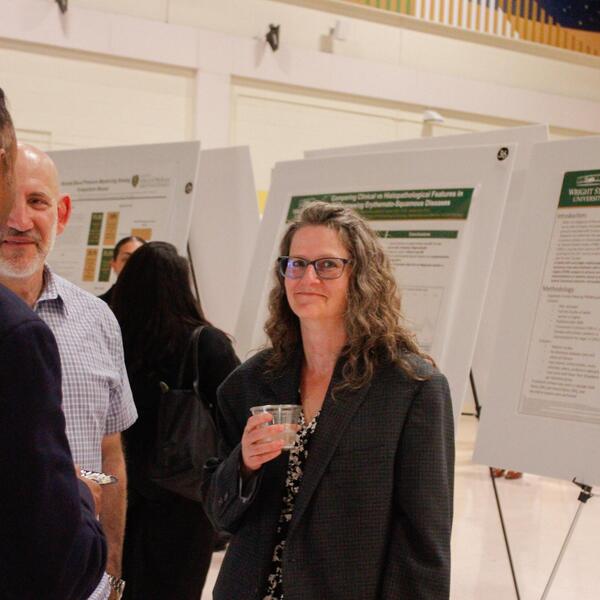 researcher explains poster