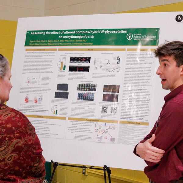 researcher explains his poster