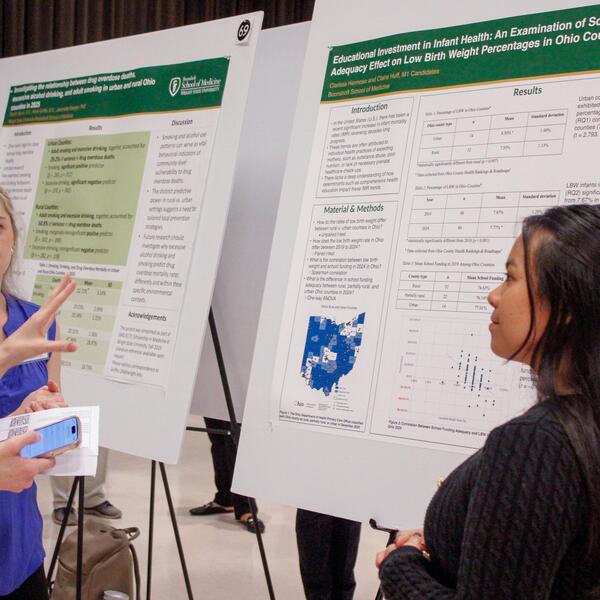 researcher presenting their poster