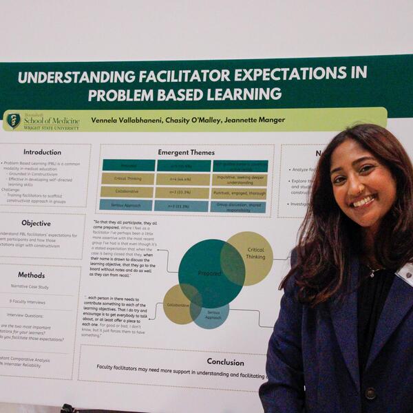 researching standing next to poster