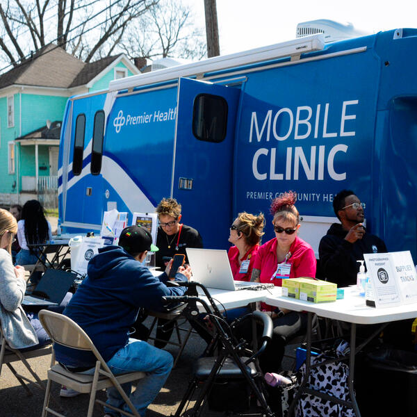 photo of people helping other check in to event