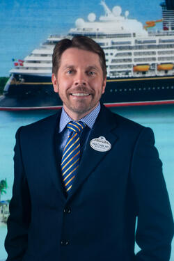 photo of Max Clark in front of Disney Cruise Line ship