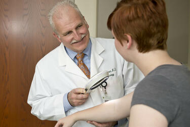 photo of a physician and patient in an exam room