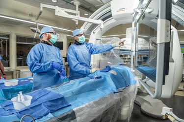 photo of a resident and physician in an operating room