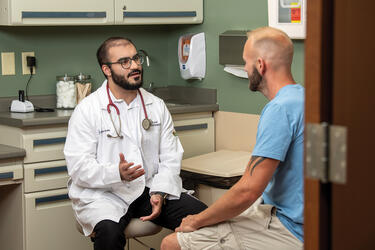 medical student and a patient in an exam room