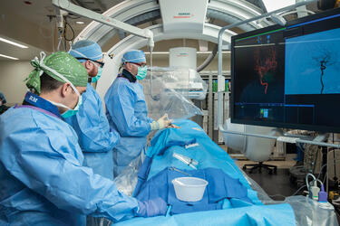 residents and a professor in a surgical room